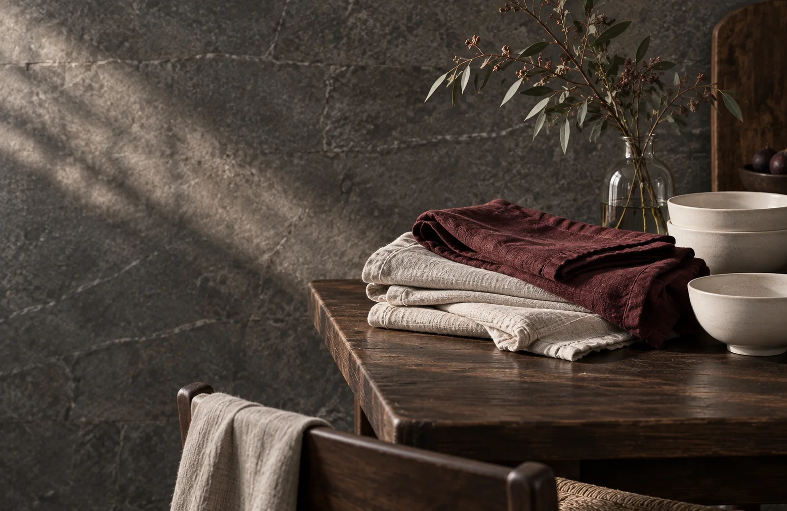 Linen napkins and ceramic bowls on a wooden table
